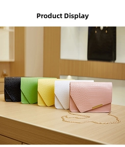 Close-up of stone texture envelope bags in various colors with golden chain straps