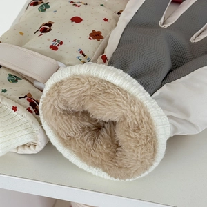 Close-up of thick plush lining and anti-slip palm texture on Christmas ski gloves