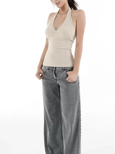 Detail of beige ribbed knit halter top with V-neckline and open back styling
