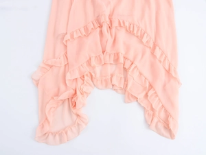 Detail of pink chiffon dress hem with elegant multilayered ruffles and irregular cut