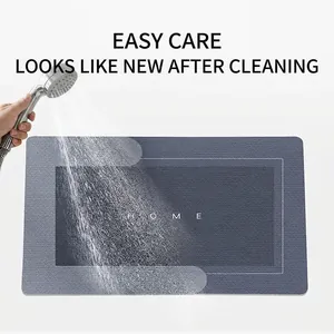 Absorbent diatomite bath mat with HOME text being cleaned by water spray