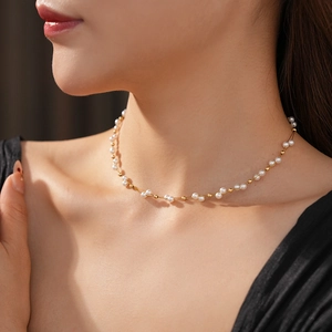 Close-up of French vintage double-layer pearl choker necklace with gold bead accents