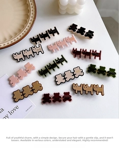 Flat lay showing variety of cute acrylic cat and bear hair clips in multiple colors