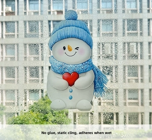 Detail of cartoon snowman window sticker showing static cling application with water droplets