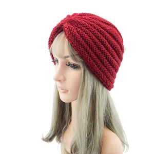 Red bohemian knitted turban hat for women featuring stylish front twisted knot and pleated design