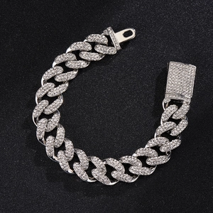 Close-up of sparkling iced out Cuban link bracelet in silver finish with rhinestones