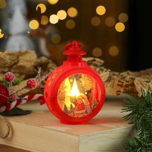 Close-up of red Christmas lantern with Santa Claus figurine and glowing LED candle