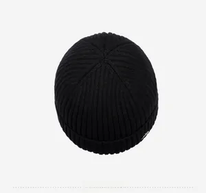 Top view of black chunky rib-knit beanie showing the six-seam crown construction
