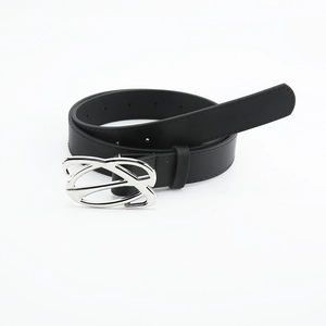 Detailed view of women's black leather belt with silver asymmetric smooth metal buckle