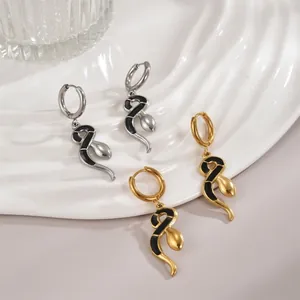 Elegant gold and silver snake hoop earrings set with black enamel drops on textured base
