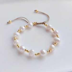 Bohemian multilayered pearl bracelet with golden beads and adjustable drawstring