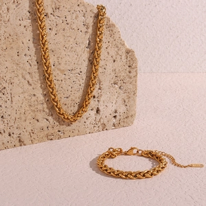 Detail of 18K gold-plated 6mm basket-weave necklace and bracelet on natural rock background