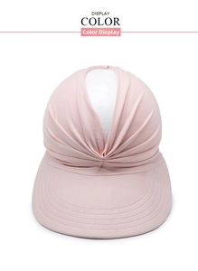 Detailed view of pale pink pleated sun visor with wide brim and multi-row stitching