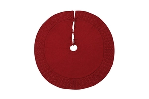 Detailed view of red knitted Christmas tree skirt with decorative hollow weave and ties