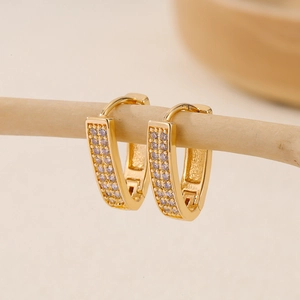 Elegant gold U-shaped earrings featuring double-row clear zircon stones on a wooden stand
