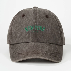Close-up of green NEW YORK U.S.A embroidery on a washed charcoal grey cotton baseball cap