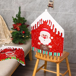 Detailed view of red Christmas chair cover with Santa and reindeer pattern on a wooden chair