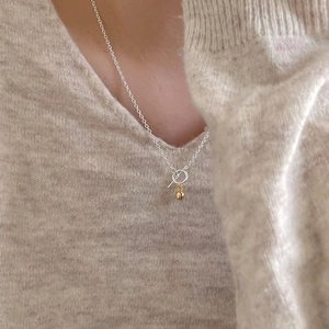 Minimalist 925 silver necklace with two-tone bell pendant and OT buckle on model