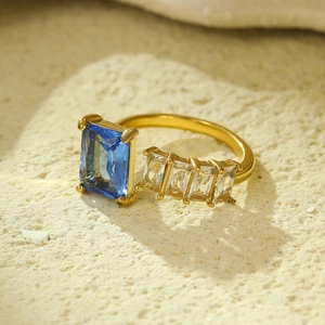 Luxurious gold stainless steel open ring featuring rectangular blue and white gemstones