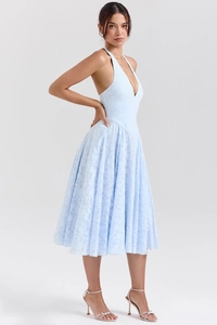 Detail showing light blue floral texture and deep V-neckline of the halter midi dress