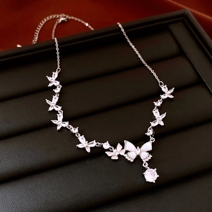Macro detail of silver adjustable butterfly necklace with cubic zirconia and shell inlays