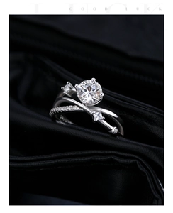 Macro shot of 1ct moissanite ring with crossover band and sparkling diamonds