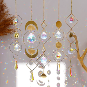 Golden metal suncatcher wind chimes with geometric moons and clear crystal prisms