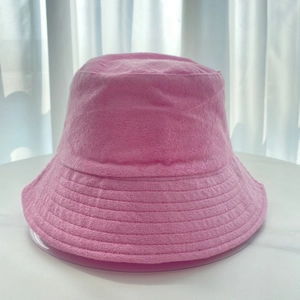 Detail shot of the pink terry cloth fabric texture and stitching on a bucket hat