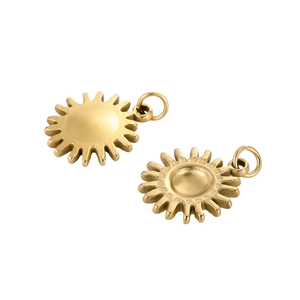 Detail shot of bright gold sun-shaped metal charms for DIY jewelry making with high polish