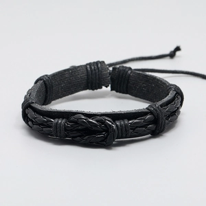 Minimalist black woven leather bracelet with center knot design on a white background