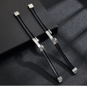 Close-up of black braided leather bracelets with polished stainless steel magnetic clasps