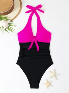 Detail of color block one-piece swimsuit with halter neck and tummy control ruching