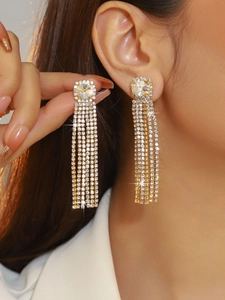 Close-up of elegant long tassel earrings with five rows of sparkling cubic zirconia stones