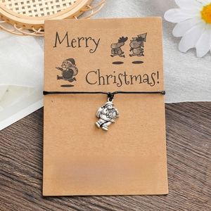Handmade Christmas wish bracelet featuring a silver Santa Claus charm on black cord
