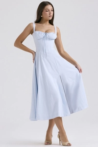 Detail view of the gathered pleated bodice and thin straps on a light blue summer dress
