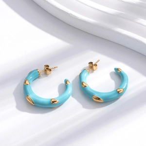 Minimalist C-shaped stainless steel blue enamel hoop earrings with golden heart patterns