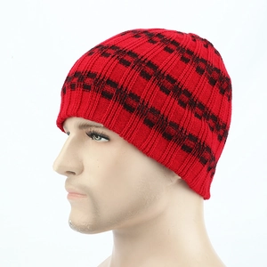 Detail of red and black checkered knit beanie with thick ribbed texture for winter warmth