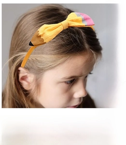 Detail of creative pencil-shaped headband for kids with fabric bow for back to school