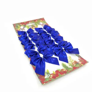 Set of 12 sparkling blue glitter Christmas tree bows on decorative white card display