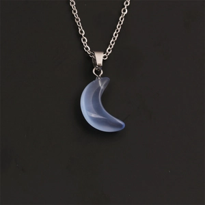 Detail of silver twist chain with a frosted light blue moon pendant on black background