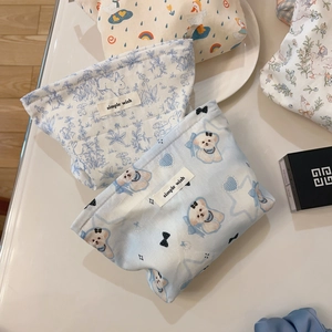 Detailed view of canvas makeup bags featuring cute cartoon prints and zipper closure