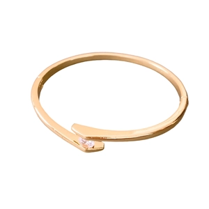 Minimalist gold plated open bangle with round zircon inlay in a sleek metal design