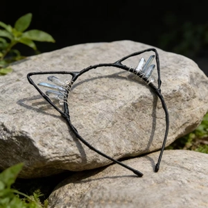 Detail of handmade cat ear headband with clear crystal stones on black metal wire