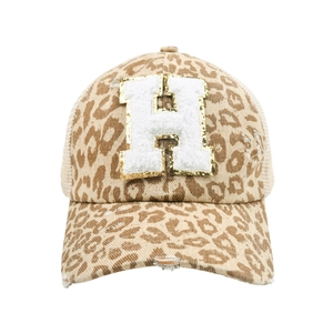 Detail of leopard print trucker hat with distressed holes and H towel embroidery patch