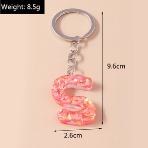 Detail view of letter S keychain with pink sequins and precise size dimensions in cm