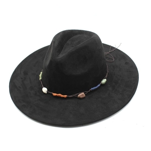 Detail of black suede fedora featuring ethnic style stone accents and colorful thread wrap