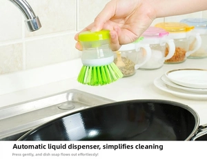 Detail of soap dispensing kitchen brush with green bristles cleaning a black frying pan