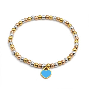 Detailed macro view of 4mm tricolor metal beads with a blue enamel heart charm bracelet