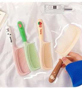 Detailed view of colorful cartoon hair brushes with 3D cute patterns and soft bristles