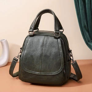 Mochila y bolso de mano vintage de cuero verde oscuro con diseño de solapa